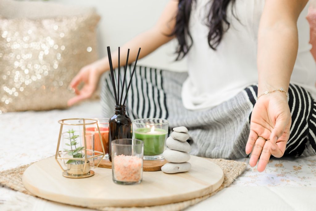 Fasting and Meditation: The Path to Wellness for Woman in white tank top holding black chopsticks.