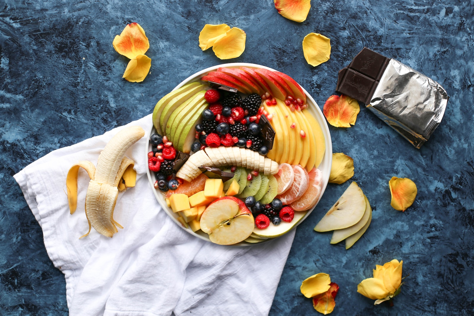 Holistic Wellness Practices” Exploring Mind-Body-Spirit Harmony in Holistic Living. bowl of sliced fruits on white textile